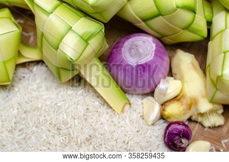 Ketupat Casing And Rice In Bamboo Container. Traditional Malay Delicacy During Malaysian Eid Festiva