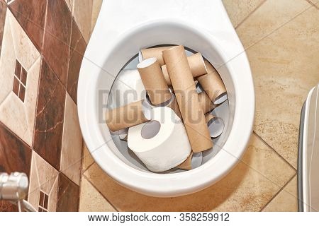 There Is A Lot Of White Toilet In It Close-up. Hard Shadows.