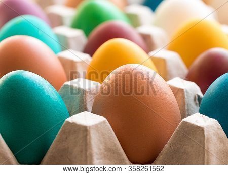 Different Colorful Easter Eggs In The Cardboard Egg Tray. Easter Decoration. Selective Focus. Macro.