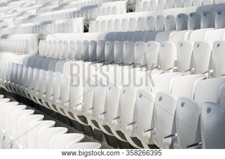 Empty White Seats In The Stadium Before The Match.