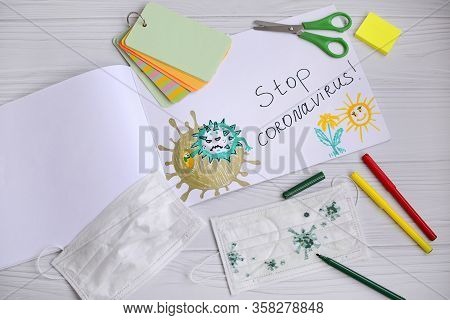 Top View Of A Children's Drawing Of A Coronavirus Molecule With Felt-tip Pens In An Album And On A M