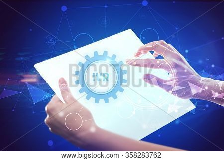 Hand holdig futuristic tablet with IVR inscription, modern technology concept