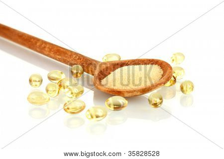 Gelatin in a wooden spoon on white background close-up