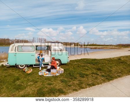 Noordoostpolder Netherlands April 2019, Classic Green And White Vw Camper Van Parked With Couple Wat