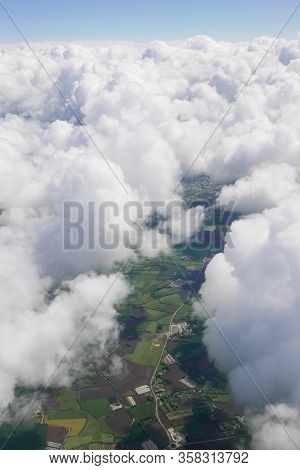 Aerial View Through The Clouds. Flight Over France