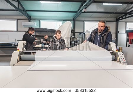 Large Group Of Technicians Works In Printing Printshop Press Hall