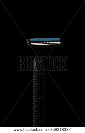 Disposable Shaving Machine In Black. Photo Razor At An Angle. Shiny Razor Blade. Very Sharp Razor.