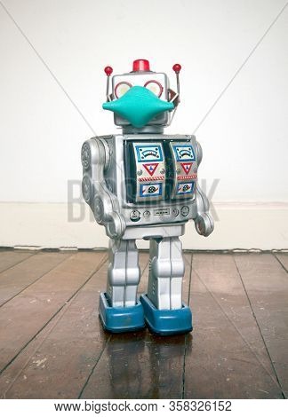 retro robot with text CIVID 19 on a old wooden floor