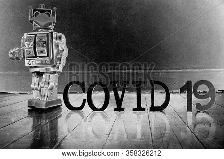 retro robot with text CIVID 19 on a old wooden floor