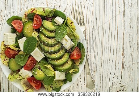 Healthy Green Salad With Avocado And Feta Cheese Close Up
