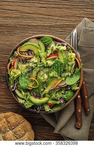 Green Lettuce Salad Meal With Fresh Vegetables On Wooden Table Background