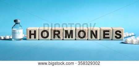Hormones - Text On Cubes. Drug In Ambula, Tablets In Blisters To Reduce Disease Symptoms