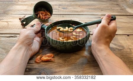 A Dish Of Tomatoes And Shrimp. Man Is Eating Shrimp Soup.
