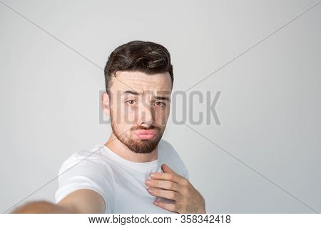 Young Man Isolated Over Background. Brutal Mysterious Guy With Strange Fasial Expression Posing On C