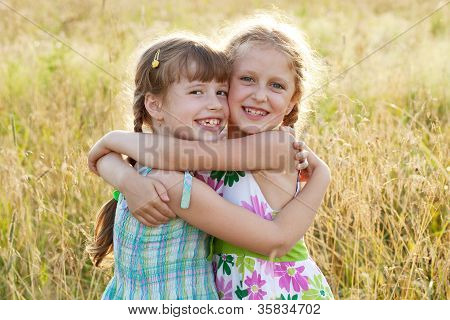 Two charming merry girl dressed in a dress