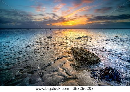 Swallow Of The Wadden Sea In The Netherlands During Sunset With Wid Angel View And Colorful Clouds.