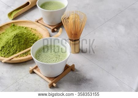Matcha Green Powder And Tea On Gray Concrete Background