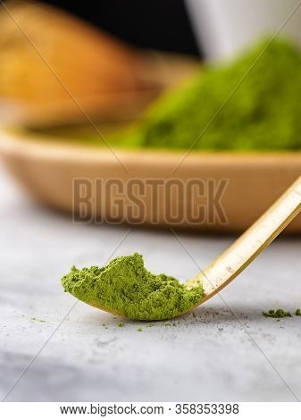 Matcha Green Powder And Tea On Gray Concrete Background