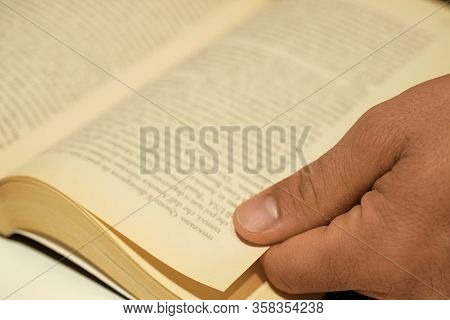 Soft Focused Human Hand Closeup While Reading An Hold Vintage Book, Knowlegde