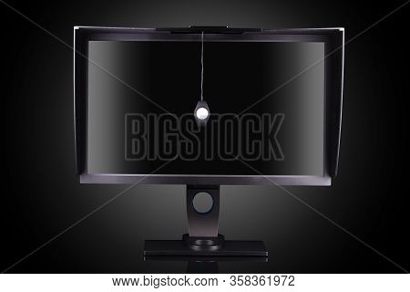Professional Monitor With Shading Hood And Calibrator Isolated On Black