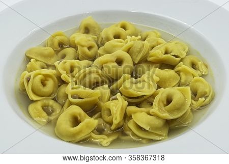 Tortellini In Brodo (broth) Isolated On White. Traditional Italian Pasta