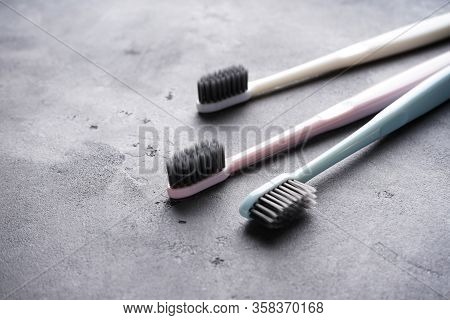 Close-up. Multi-colored Toothbrushes On A Gray Background.