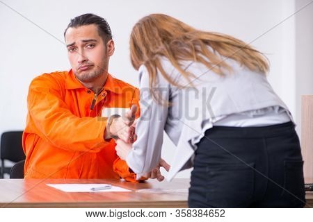 Young man meeting with advocate in pre-trial detention