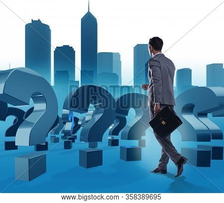 Businessman in uncertainty concept with question marks