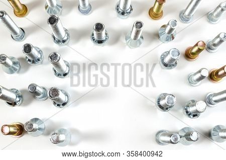 Nuts And Upright Studs And Bolts For A Car On A Table With A Place For Inscription
