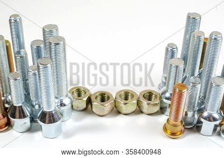 Nuts And Upright Studs And Bolts For A Car On A Table With A Place For Inscription