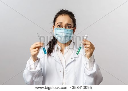 Doctors, Infectionist, Research And Covid19 Concept. Portrait Of Concerned, Confused Young Asian Sci