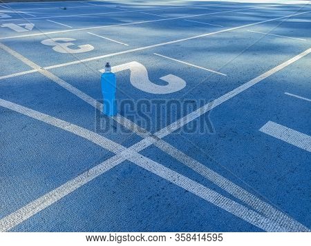 Isotonic Energy Drink. Bottle With Blu Transparent Liquid, Sport Beverage On A Sports Ground. Start 