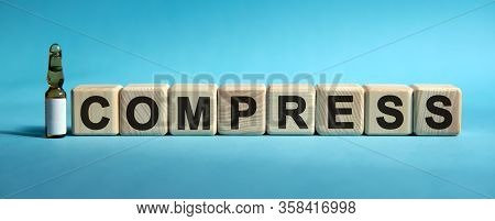 Compress - Word On Cubes. Drug In Ambula To Reduce Disease Symptoms On A Blue Background