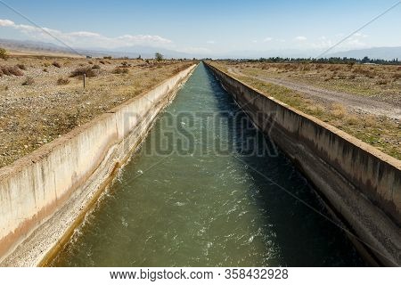 Irrigation Canal Chuy Province. Water Flowing In An Irrigation Canal In Kyrgyzstan.