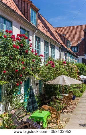 Colorful Flowers At The Facade Of A White House In Flensburg, Germany