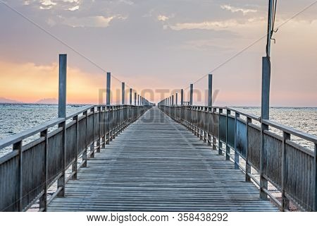 Long Pontoon On The Red Sea In Egypt. Pontoon For Descent Into The Water.