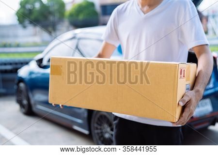 Delivery Man Carrying Cardboard Box For Sending To Receiver Customer By Transportation System Hatchb