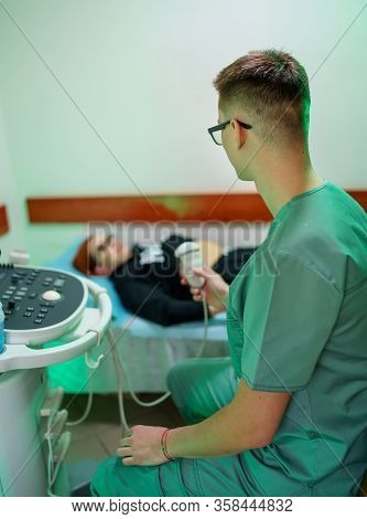 Ultrasound Doctor Makes An Ultrasound Of The Abdominal Cavity Of The Boy. The Boy Is Being Examined 