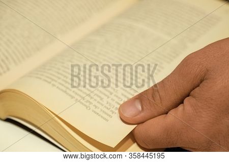 Rome, Italy - March 29 2020: Soft Focused Human Hand Closeup While Reading An Hold Vintage Book, Kno