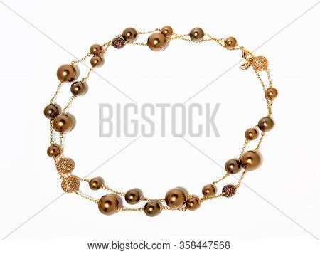 Women`s Necklace Of Purple And Golden Beads On White 
Background. Top View