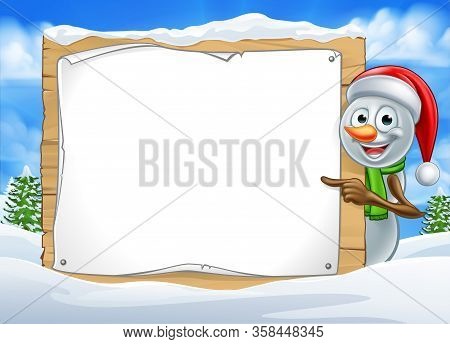 A Happy Christmas Snowman Cartoon Character In A Winter Scene Peeking Around Pointing At A Sign