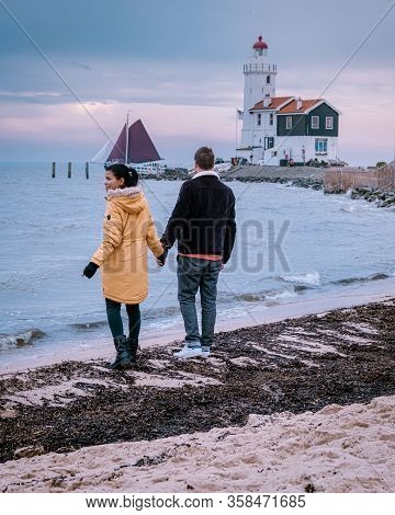 Paard Van Marken Lighthouse In The Netherlands, Couple Visiting The Fishing Village Of Marken Hollan