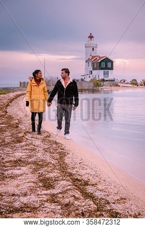 Paard Van Marken Lighthouse In The Netherlands, Couple Visiting The Fishing Village Of Marken Hollan