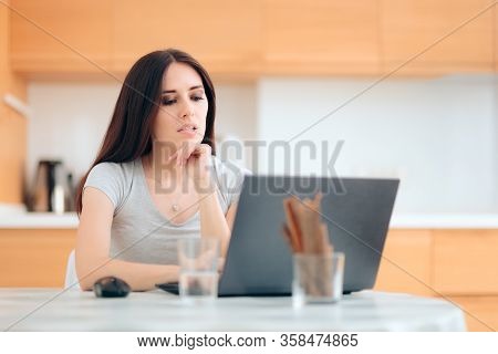 Worried Woman Reading The News At Home In The Kitchen