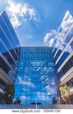 Johannesburg, South Africa, 15th March - 2020: Glass Facade Of Modern Office Building With View Towa