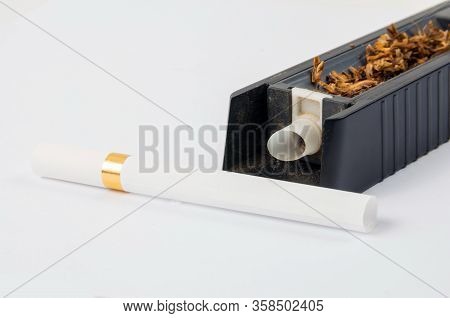 Tobbaco Cigarette Making Machine On The White