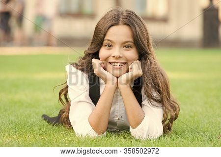 Future Woman. Happy Girl Back To School. Small Girl Relax On Green Grass. Little Girl Smile With Lon