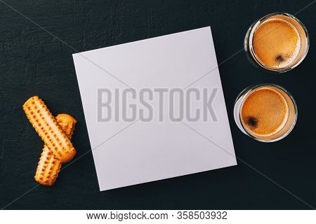 Two Shots Of Espresso In Glass Transparent Cups, Bisuits And White Square Paper Card For Text On A D