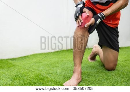 Close Up On Knee Injury. The Man Use Hands Hold On His Knee While Running