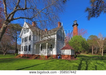 Keepers Quarters In Front Of The Red Brick Structure Of The Currituck Beach Lighthouse With Spring T